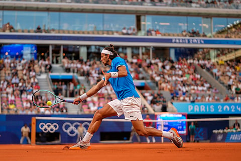 Lorenzo Musetti returns the ball against Novak Djokovic